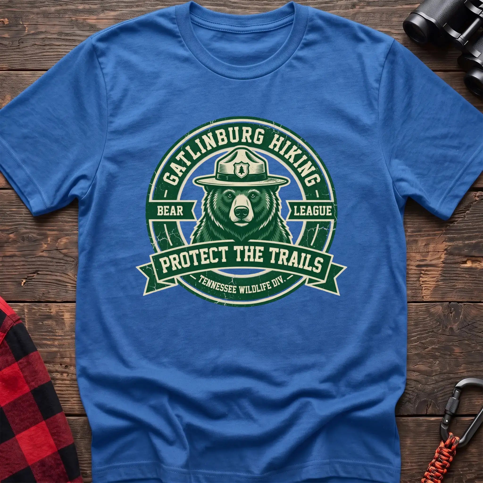 Heather royal t-shirt with circular badge of a bear in a ranger hat reading Gatlinburg Hiking Bear League Protect the Trails
