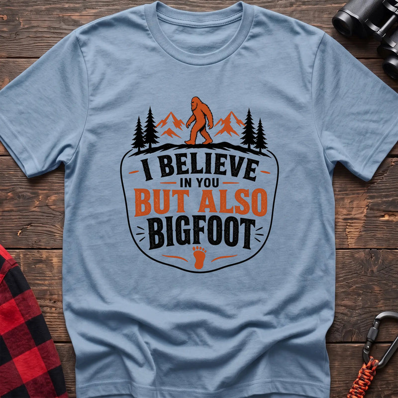 Light blue hiking t-shirt with Bigfoot on a mountain ridge and I Believe in You But Also Bigfoot text