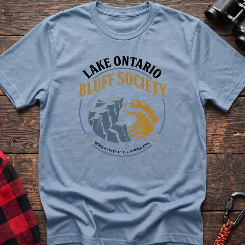 Light blue hiking t-shirt with Lake Ontario Bluff Society badge showing a cliff, wave, and Members Keep to the Marked Edge