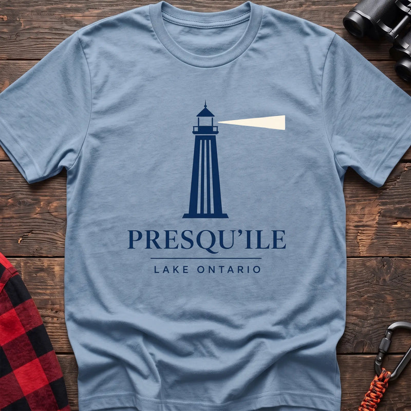 Light blue cotton t-shirt with a navy lighthouse graphic and the text “Presqu’ile Lake Ontario”