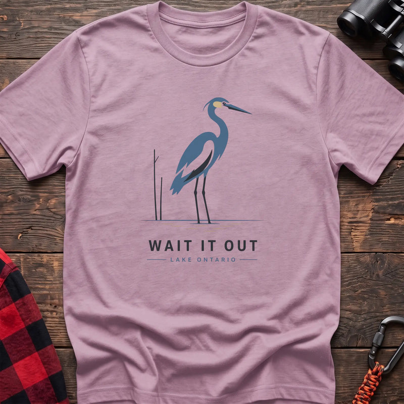 Light pink hiking t-shirt with a blue heron graphic and the text “Wait It Out Lake Ontario”