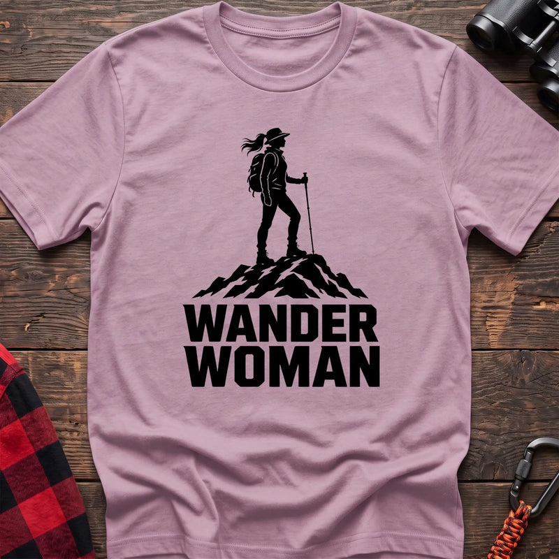 Light pink cotton hiking t-shirt with black silhouette of a female hiker on a mountain peak and bold Wander Woman text