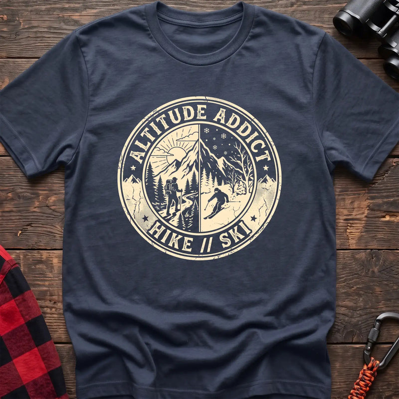 Navy t-shirt with circular badge graphic of a hiker and skier on split mountain scenes, reading Altitude Addict Hike Ski