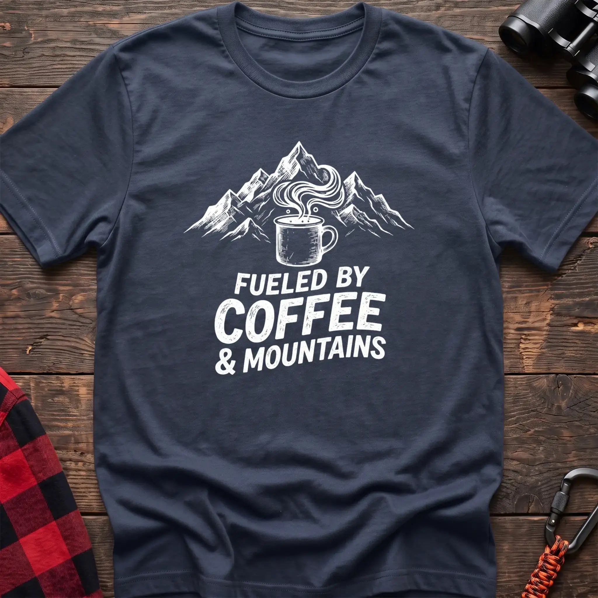 Navy t-shirt with white graphic of a steaming coffee mug in front of mountains and the text Fueled by Coffee & Mountains