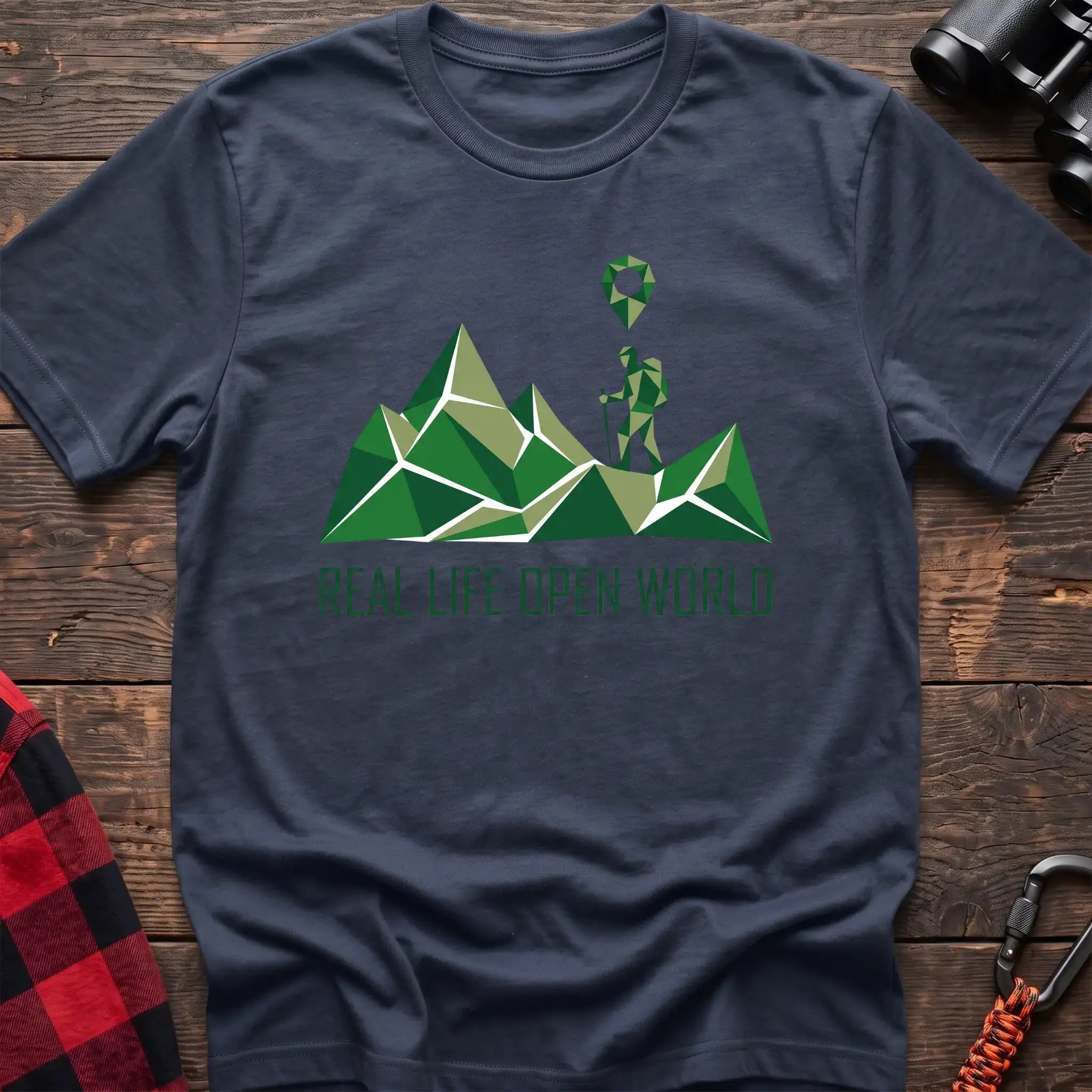 Navy t-shirt with geometric green mountain graphic and a hiker silhouette under a map pin, reading Real Life Open World