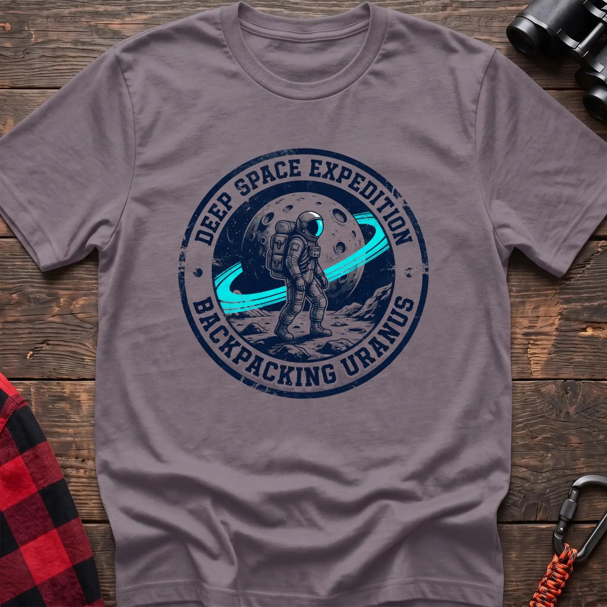 Paragon t-shirt with circular badge graphic of an astronaut backpacking on Uranus, reading Deep Space Expedition Backpacking Uranus
