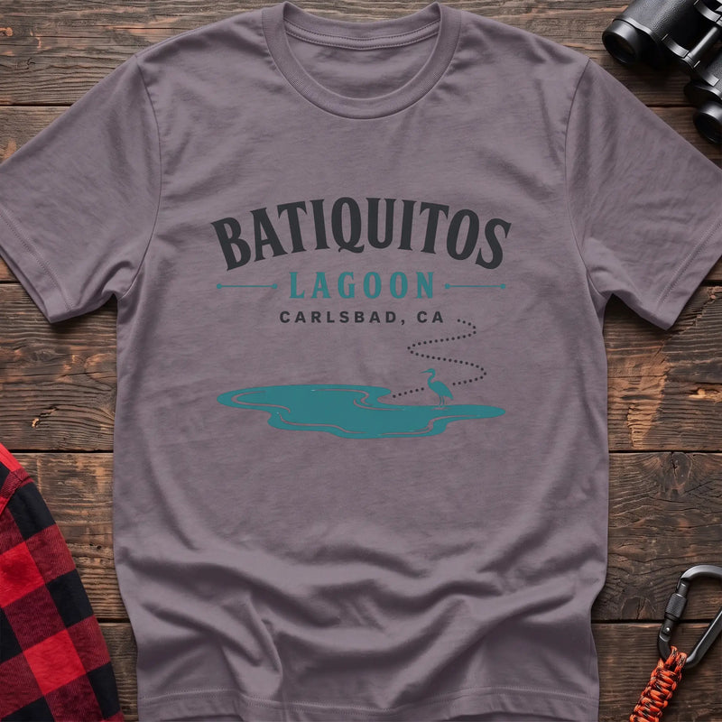 Paragon cotton t-shirt with a heron and lagoon graphic and Batiquitos Lagoon Carlsbad CA text on rustic wood