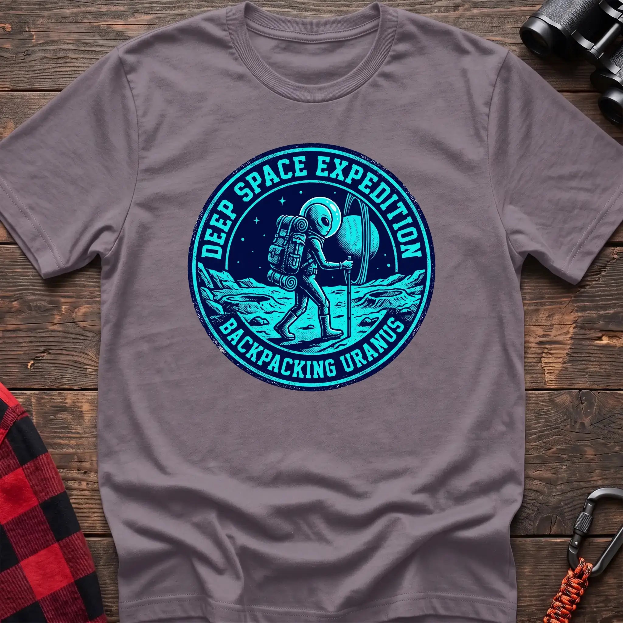 Paragon t-shirt with circular badge graphic of an alien backpacking on Uranus, reading Deep Space Expedition Backpacking Uranus