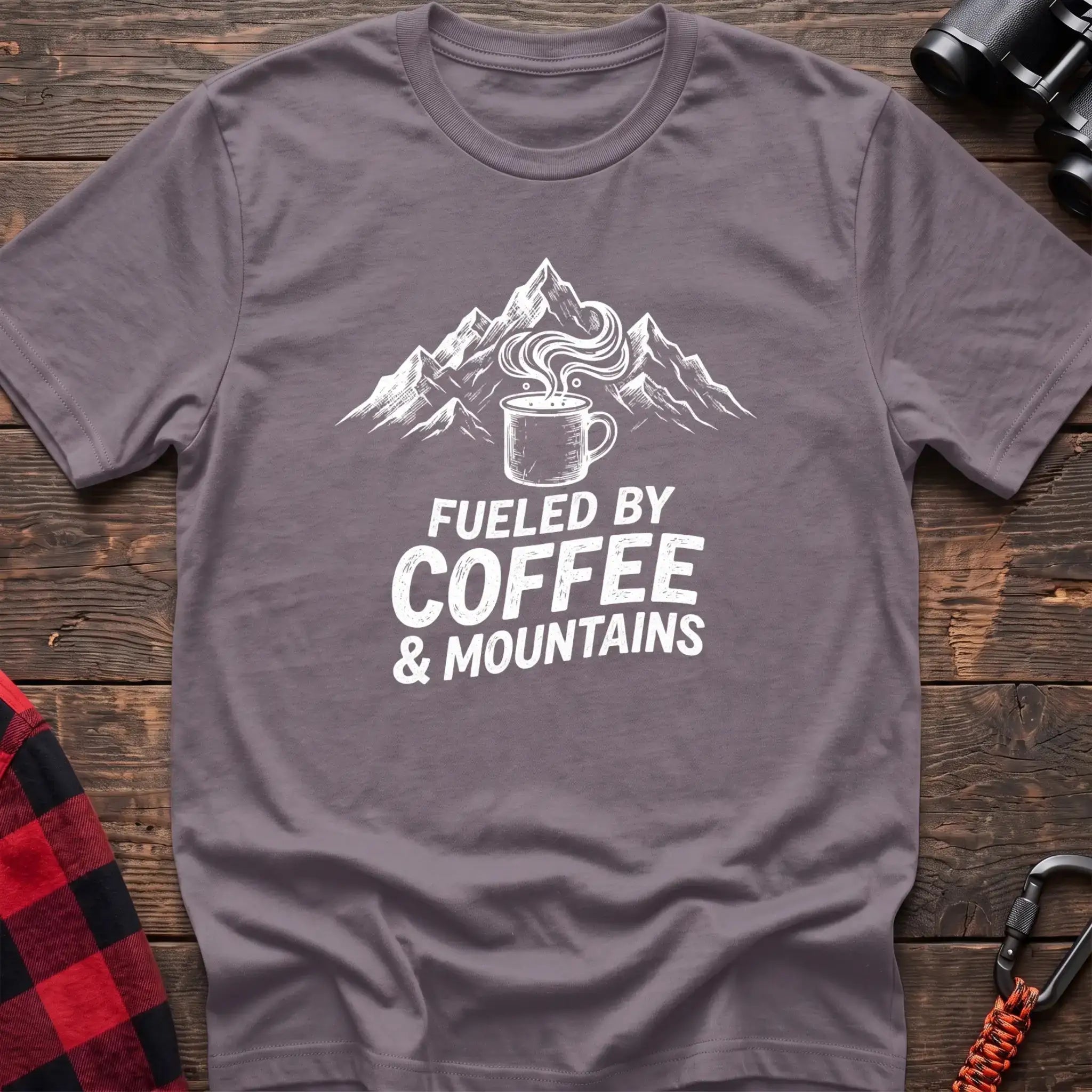 Paragon t-shirt with white graphic of a steaming coffee mug in front of mountains and the text Fueled by Coffee & Mountains