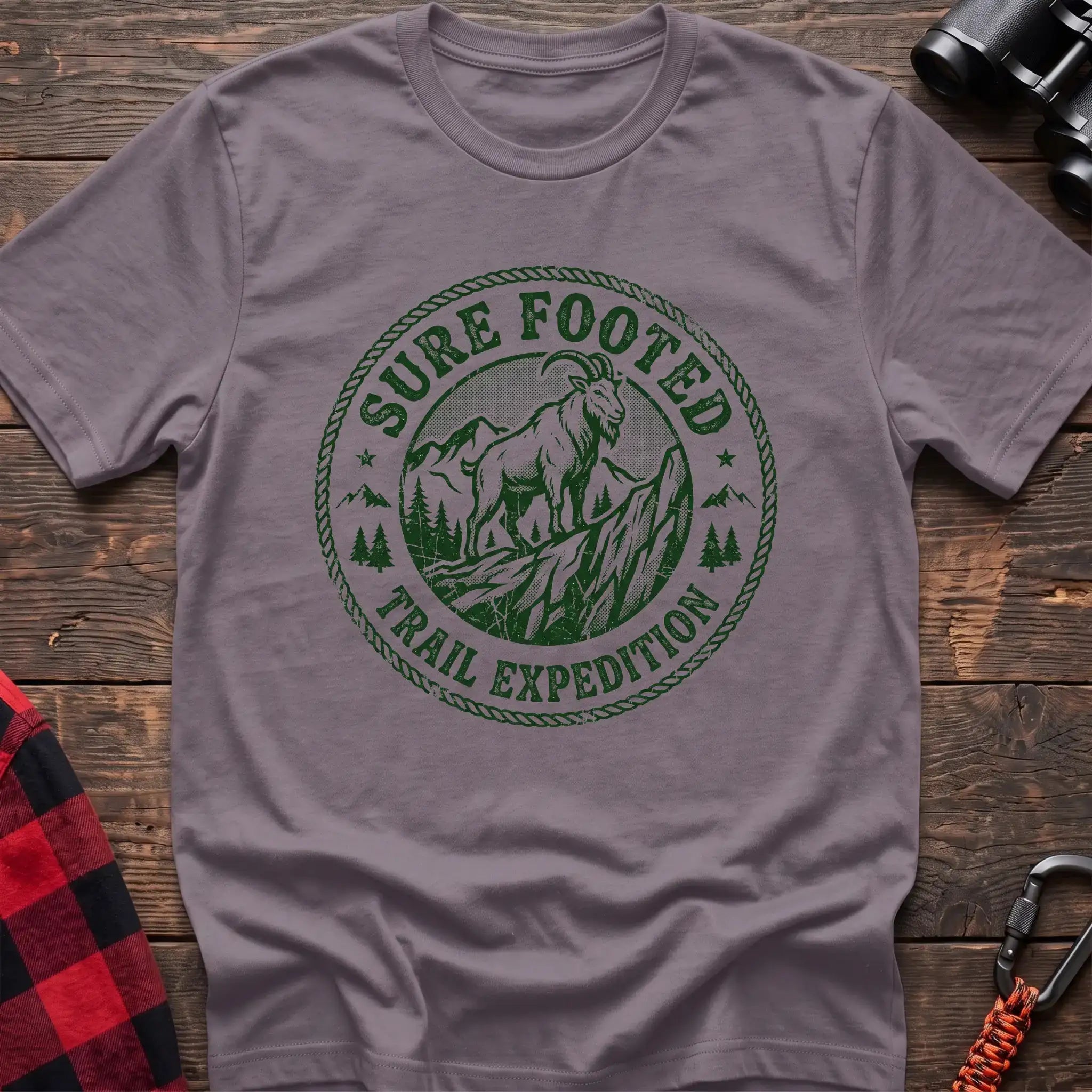 Paragon t-shirt with circular badge graphic of a mountain goat on a rocky peak reading Sure Footed Trail Expedition