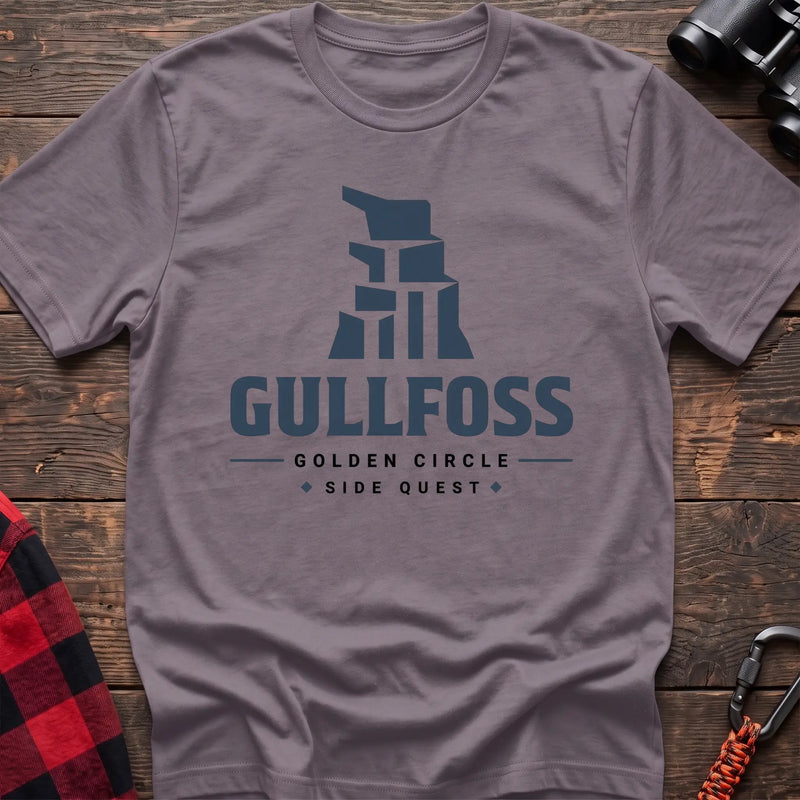 Paragon cotton t-shirt with a stylized waterfall graphic and Gullfoss Golden Circle Side Quest text on rustic wood