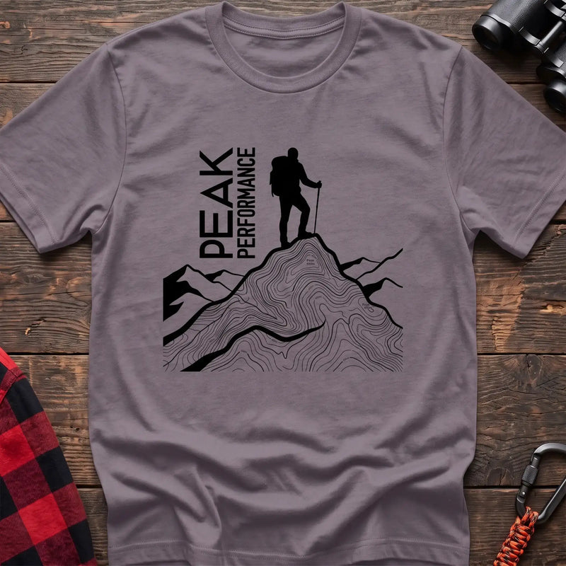 Paragon t-shirt with hiker silhouette on a topographic mountain peak and the text Peak Performance