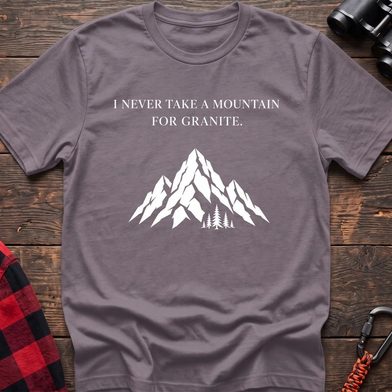 Paragon cotton t-shirt with a mountain graphic and I Never Take a Mountain for Granite text on rustic wood