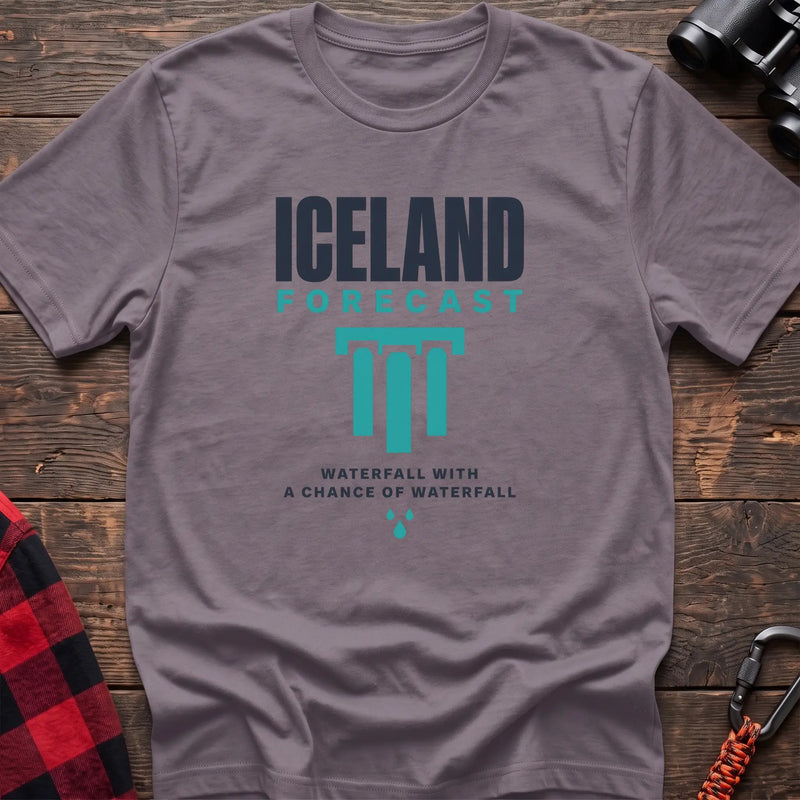Paragon cotton t-shirt with an Iceland Forecast graphic and Waterfall with a Chance of Waterfall text on rustic wood