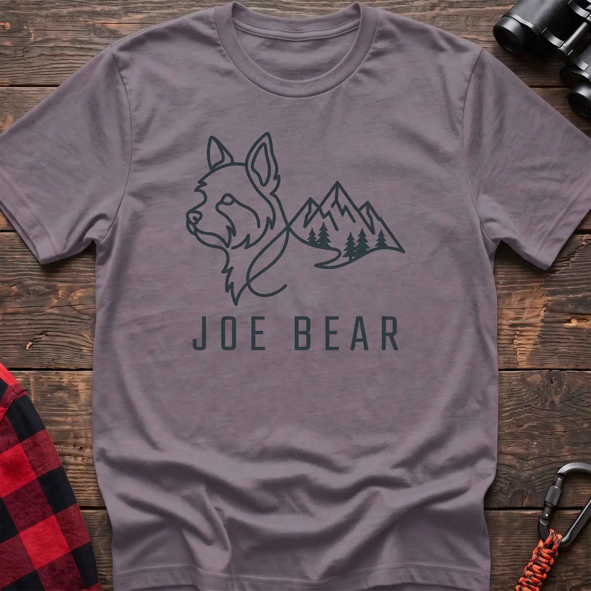 Paragon t-shirt with dark line art of a yorkie dog head blending into mountains and pine trees, with the text Joe Bear