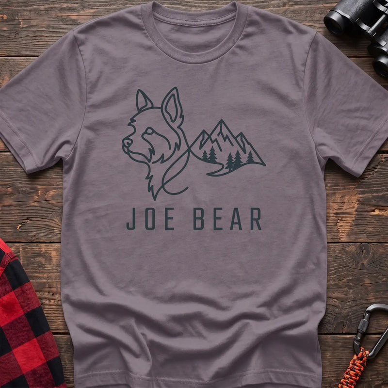 Paragon t-shirt with dark line art of a yorkie dog head blending into mountains and pine trees, with the text Joe Bear
