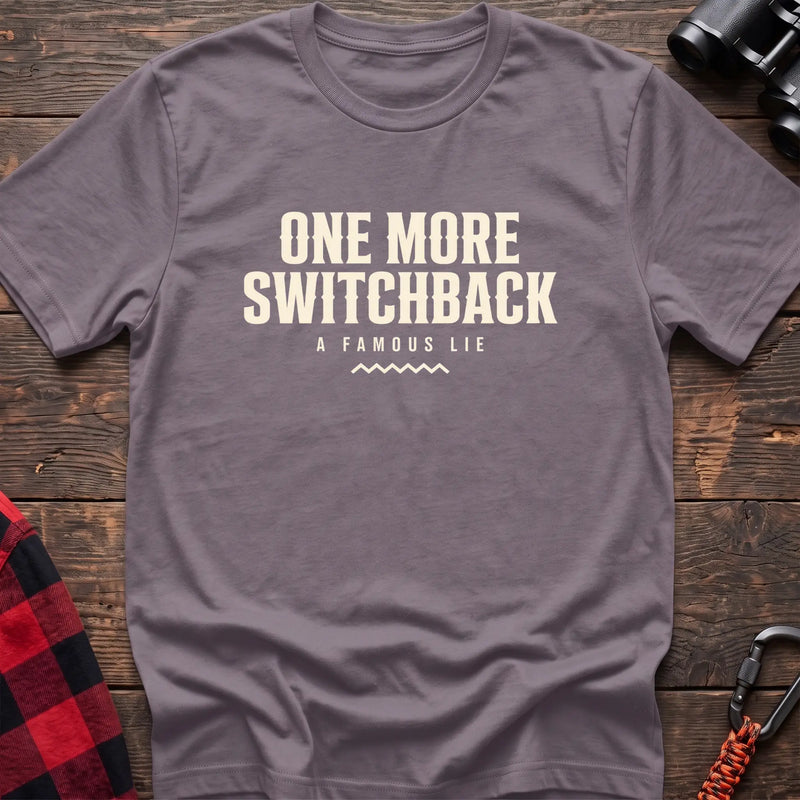 Paragon cotton t-shirt with One More Switchback A Famous Lie text on rustic wood