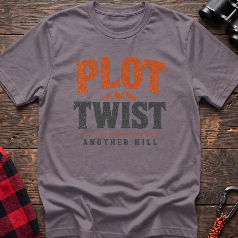 Paragon cotton t-shirt with a mountain graphic and Plot Twist Another Hill text on rustic wood