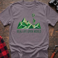 Paragon t-shirt with geometric green mountain graphic and a hiker silhouette under a map pin, reading Real Life Open World