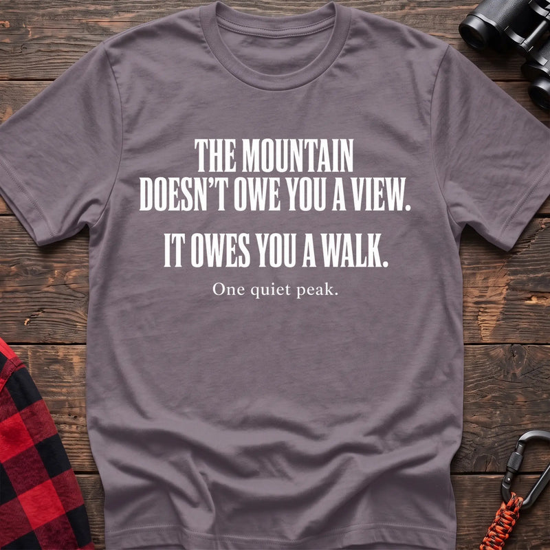 Paragon cotton t-shirt with The Mountain Doesn’t Owe You a View It Owes You a Walk text on rustic wood