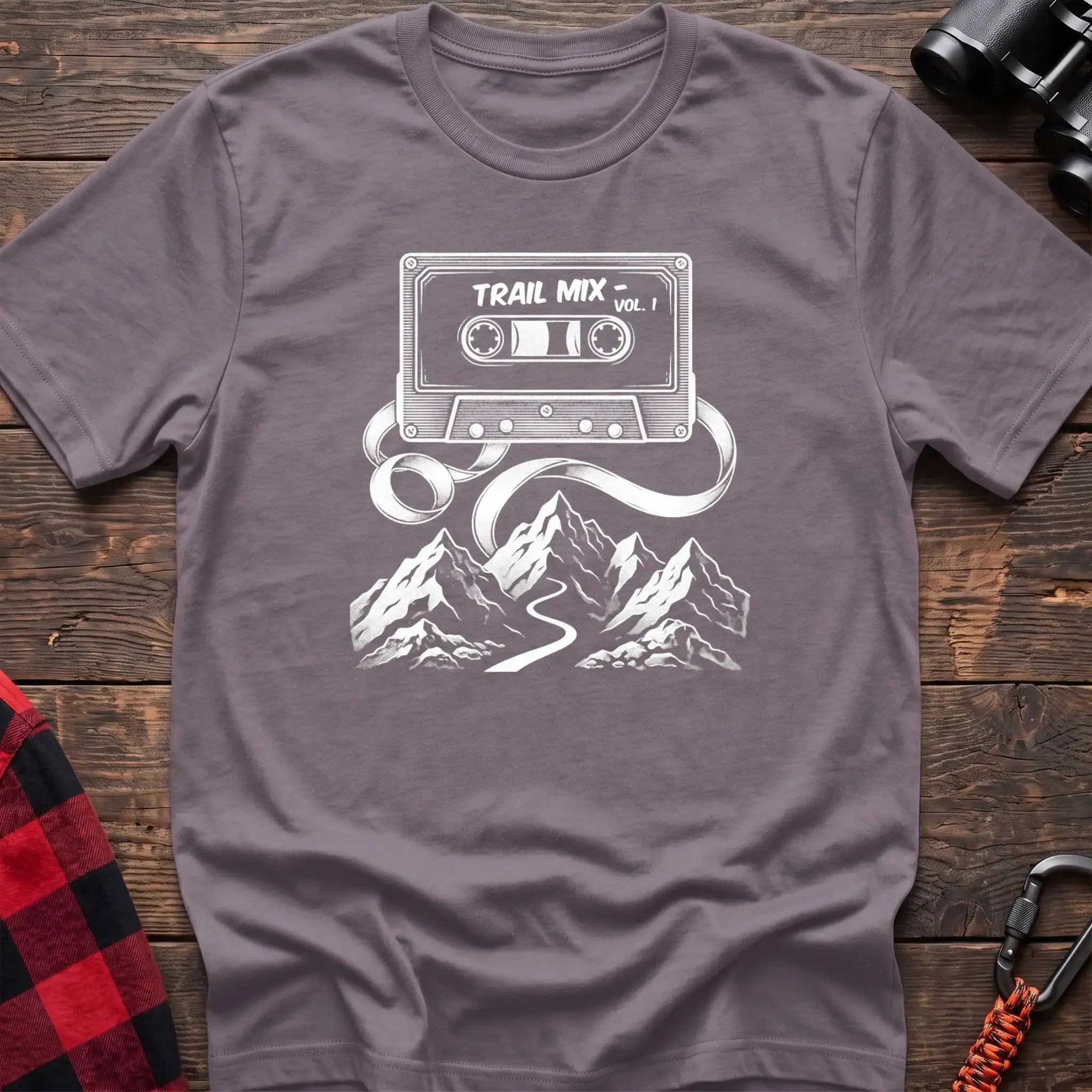 Paragon t-shirt with white cassette tape graphic labeled Trail Mix Vol. 1, with tape unspooling into a trail through mountains