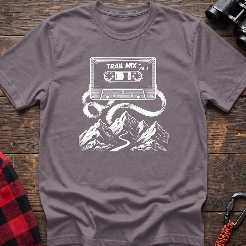 Paragon t-shirt with white cassette tape graphic labeled Trail Mix Vol. 1, with tape unspooling into a trail through mountains