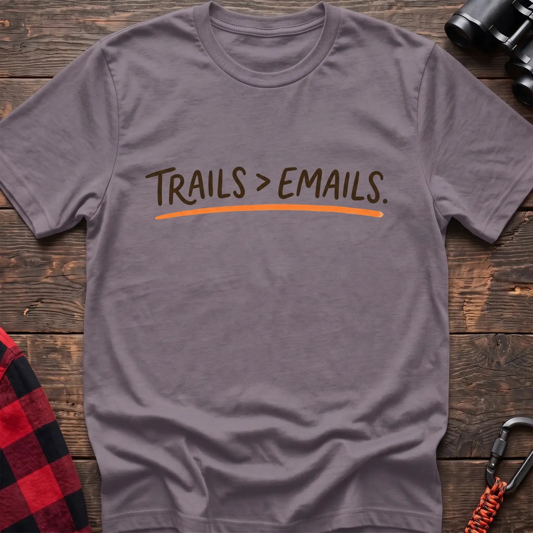 Paragon t-shirt with brown handwritten-style text reading Trails greater than Emails and an orange underline