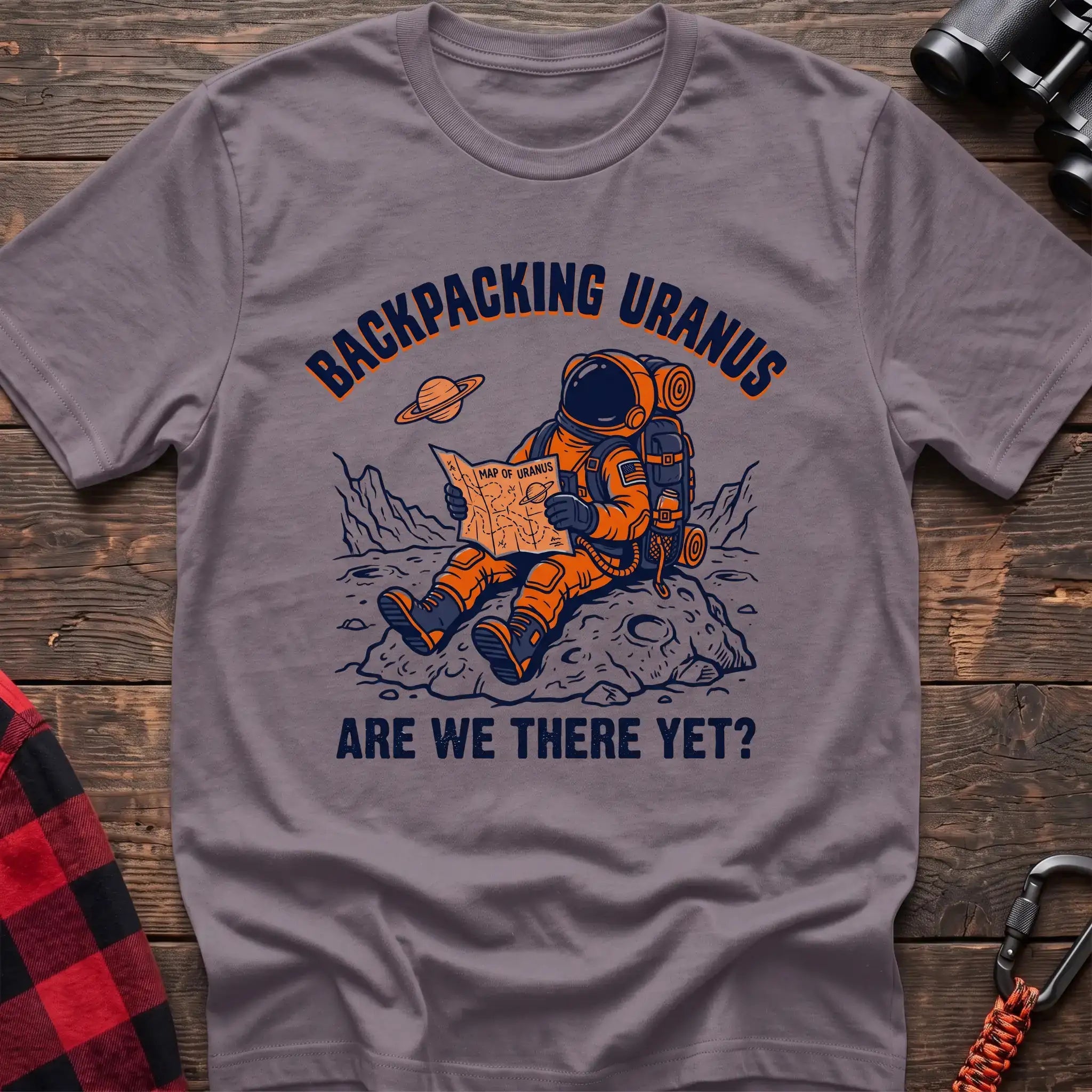 Paragon t-shirt with astronaut sitting on a rock reading a Map of Uranus and the text Backpacking Uranus Are We There Yet