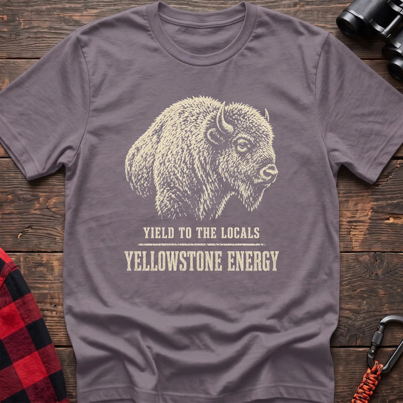 Paragon cotton t-shirt with a bison graphic and Yield to the Locals Yellowstone Energy text on rustic wood