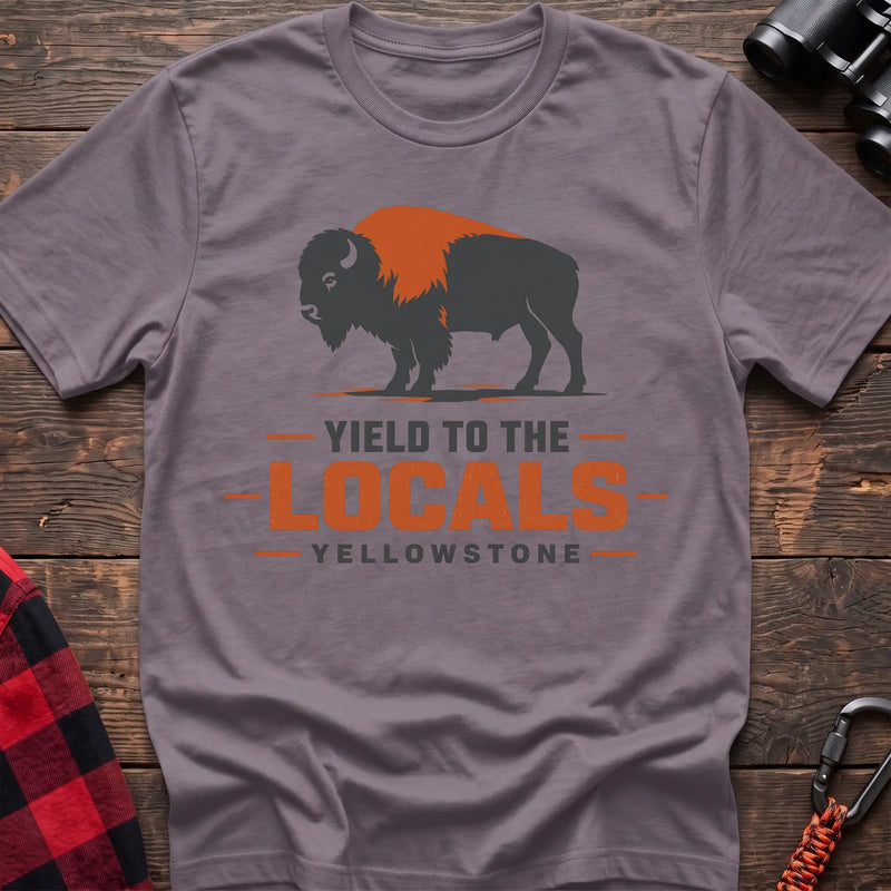 Paragon cotton t-shirt with a bison graphic and Yield to the Locals Yellowstone text on rustic wood