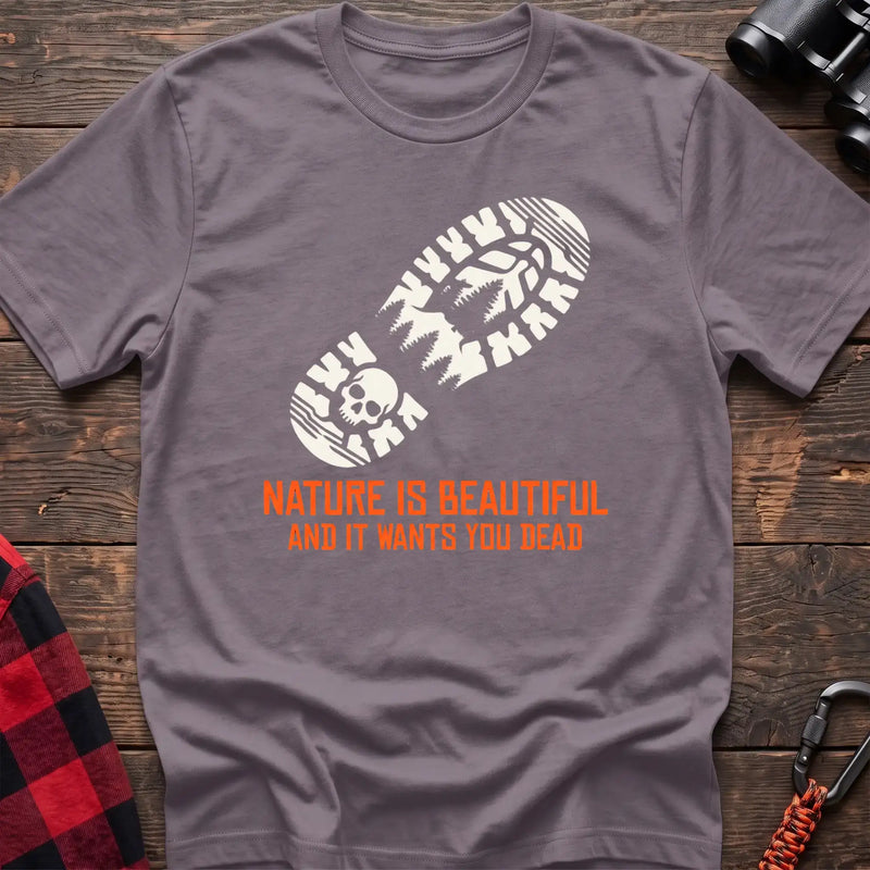 Paragon t-shirt with white boot print graphic featuring a skull and pine trees, and orange text reading Nature Is Beautiful And It Wants You Dead