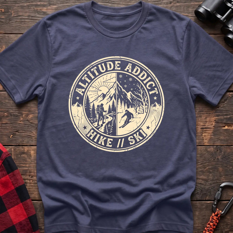 Purple t-shirt with circular badge graphic of a hiker and skier on split mountain scenes, reading Altitude Addict Hike Ski