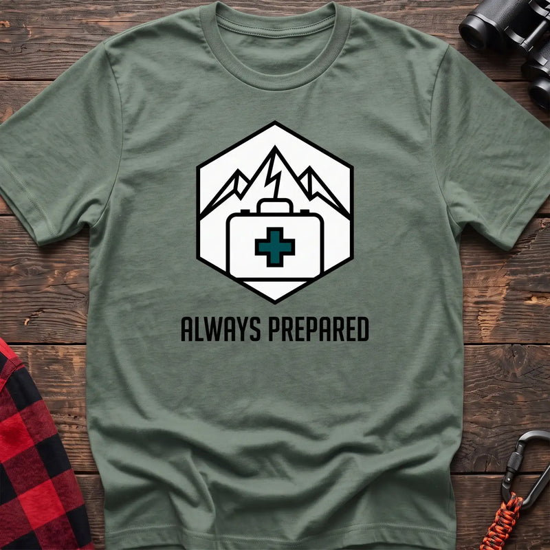 Sage t-shirt with hexagonal badge graphic of mountains and a first aid kit, reading Always Prepared