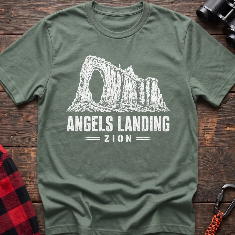 Sage cotton t-shirt with a canyon graphic and Angels Landing Zion text on rustic wood