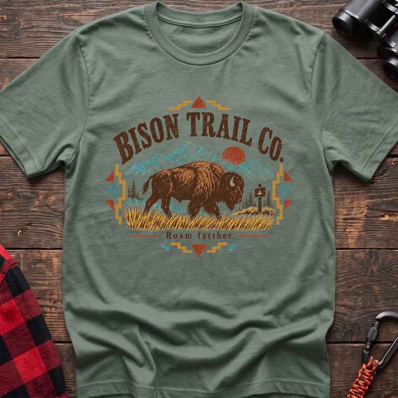 Sage cotton t-shirt with a bison and mountain graphic and Bison Trail Co text on rustic wood