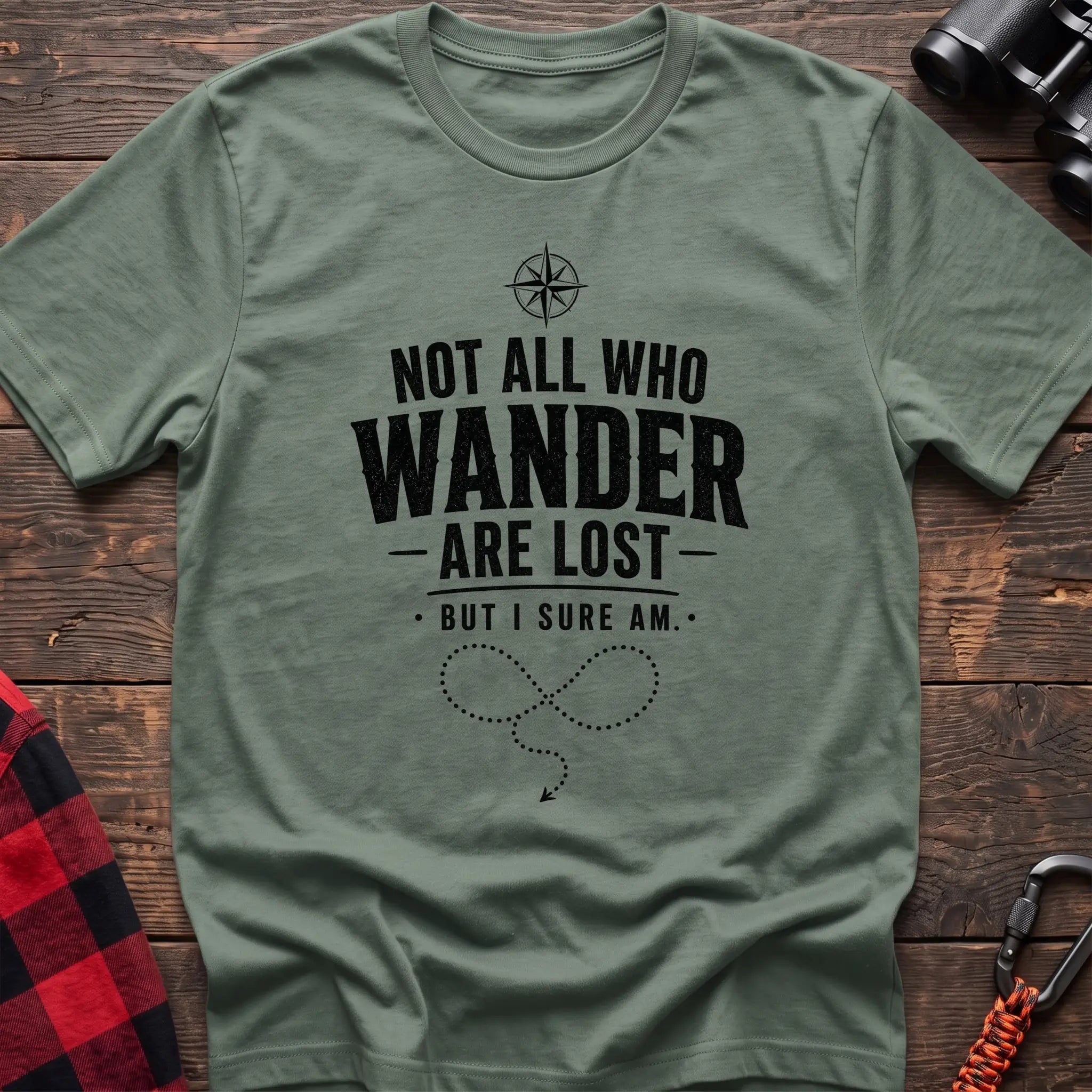 Sage cotton hiking t-shirt with compass, "Not all who wander are lost but I sure am" quote, and dotted wandering path graphic