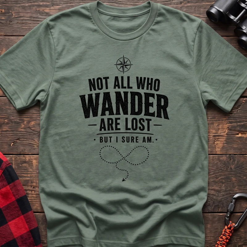 Sage cotton hiking t-shirt with compass, "Not all who wander are lost but I sure am" quote, and dotted wandering path graphic