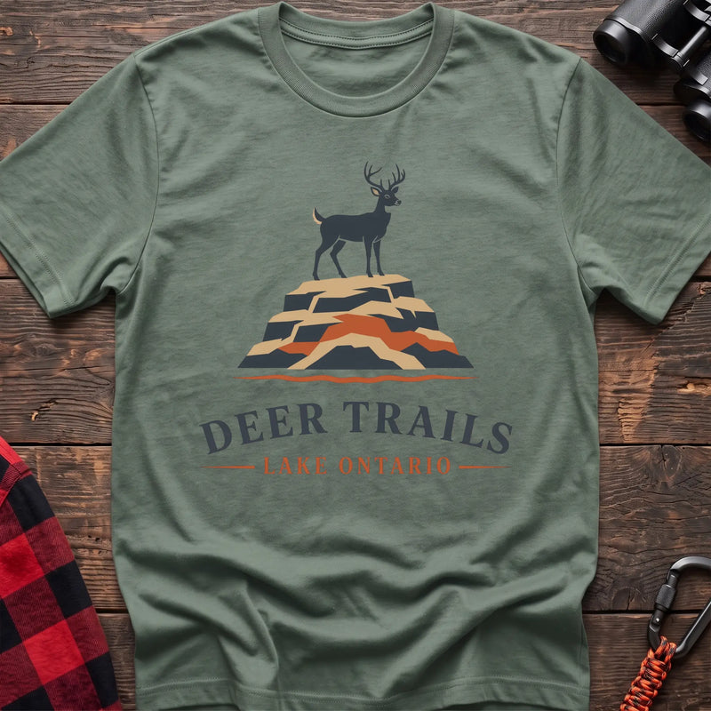 Sage hiking t-shirt with a deer on a rocky bluff and the text “Deer Trails Lake Ontario”