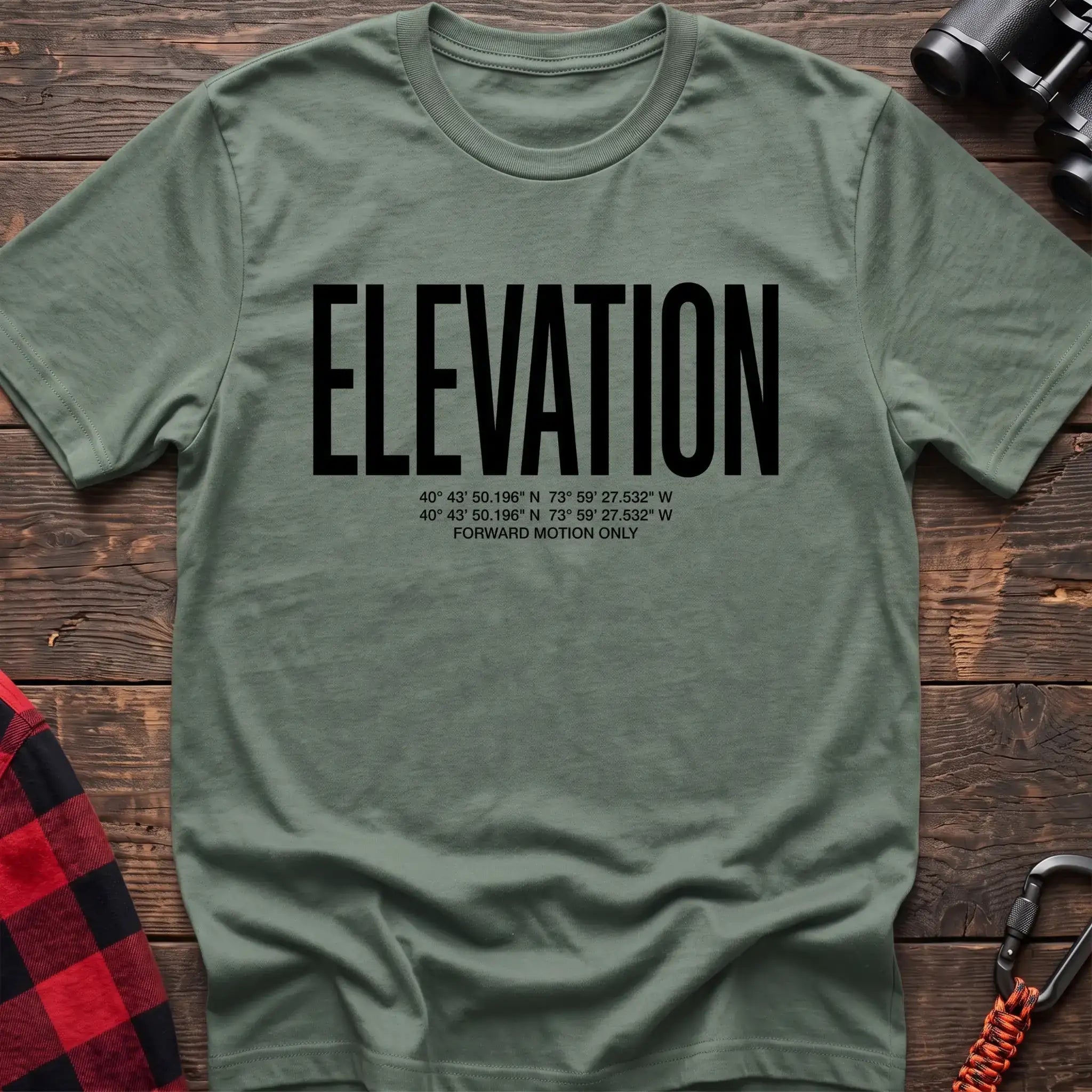 Sage t-shirt with large black text reading Elevation and GPS coordinates with Forward Motion Only
