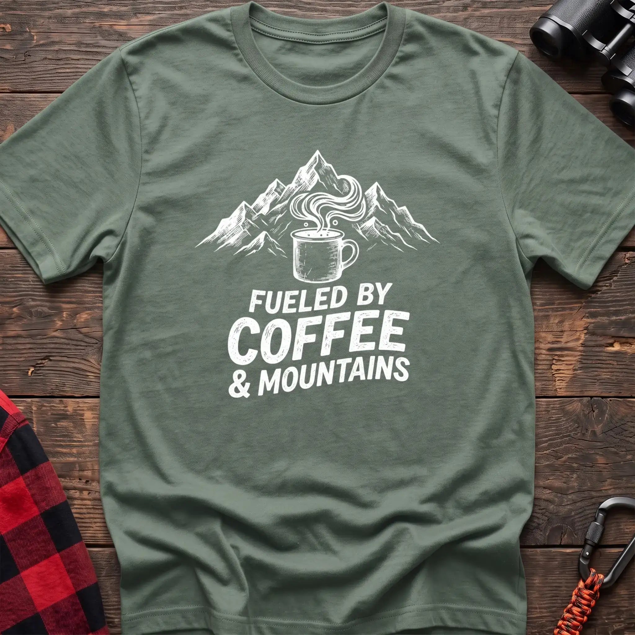 Sage t-shirt with white graphic of a steaming coffee mug in front of mountains and the text Fueled by Coffee & Mountains