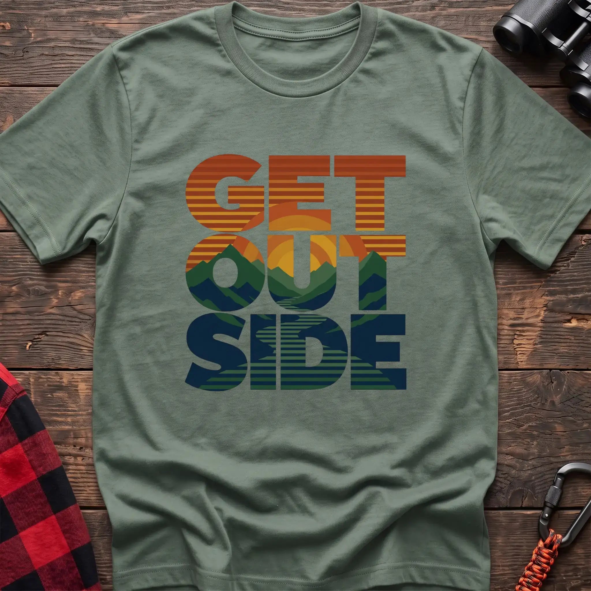 Sage t-shirt with retro sunset and mountain graphic integrated into the text Get Outside