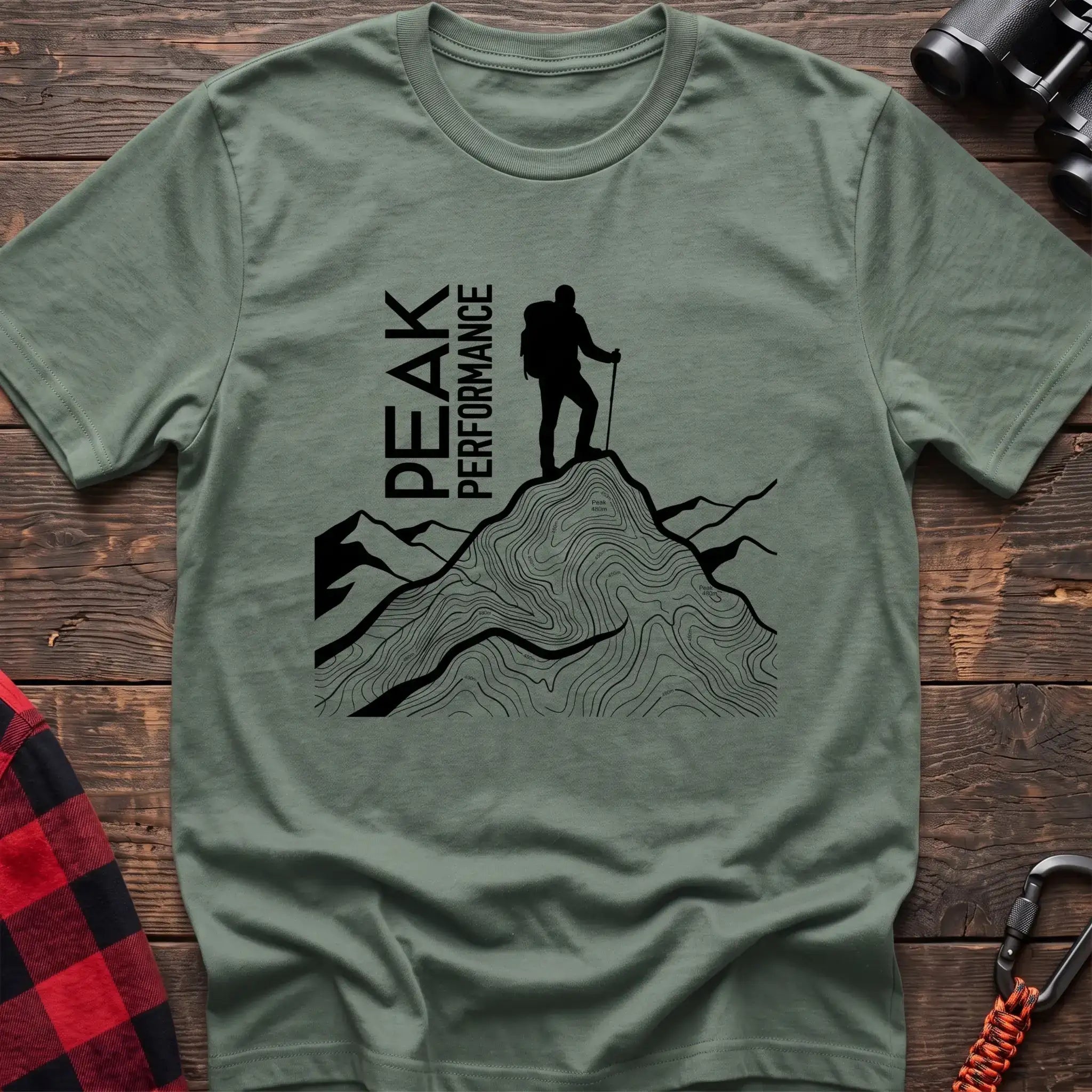 Sage t-shirt with hiker silhouette on a topographic mountain peak and the text Peak Performance