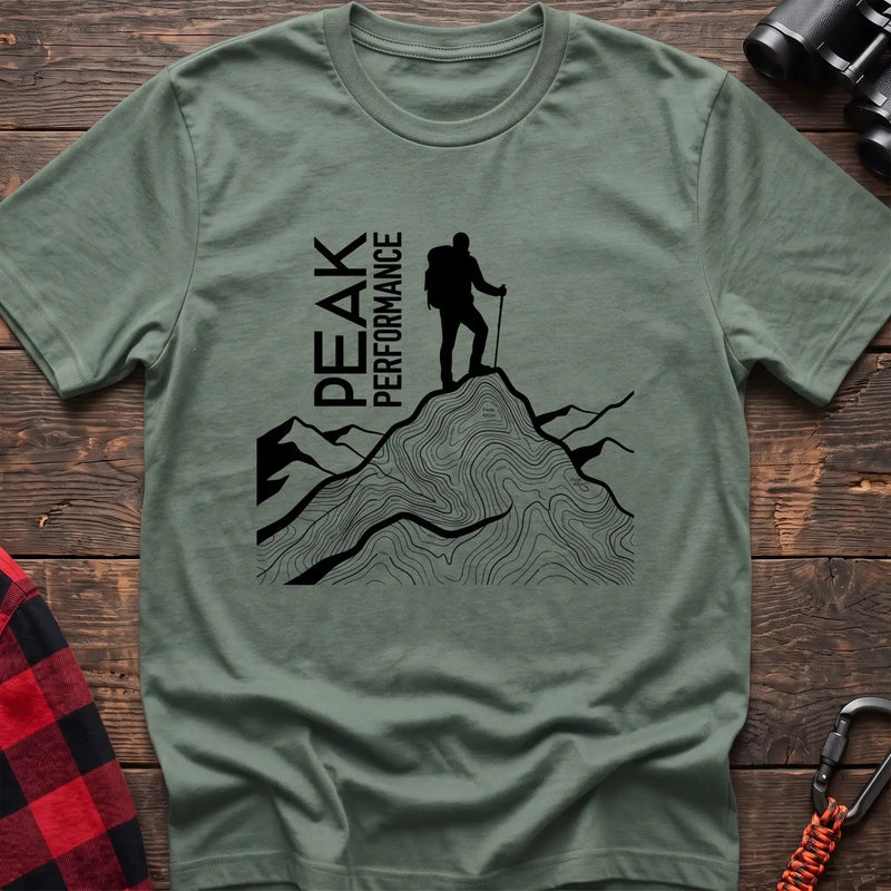 Sage t-shirt with hiker silhouette on a topographic mountain peak and the text Peak Performance