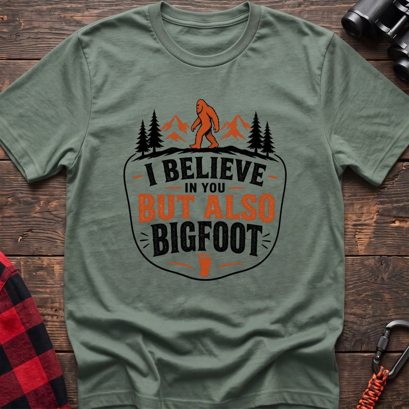 Sage hiking t-shirt with Bigfoot on a mountain ridge and I Believe in You But Also Bigfoot text