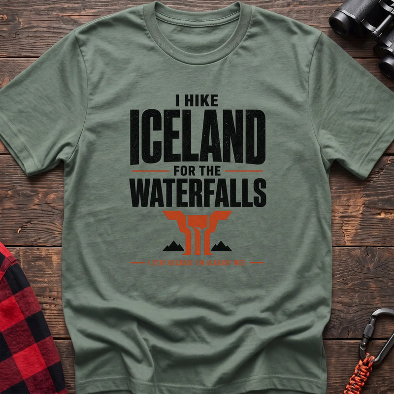 Sage cotton t-shirt with a waterfall graphic and I Hike Iceland for the Waterfalls text on rustic wood