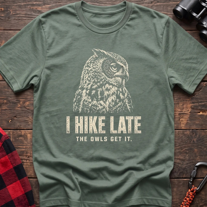 Sage cotton t-shirt with an owl graphic and I Hike Late The Owls Get It text on rustic wood