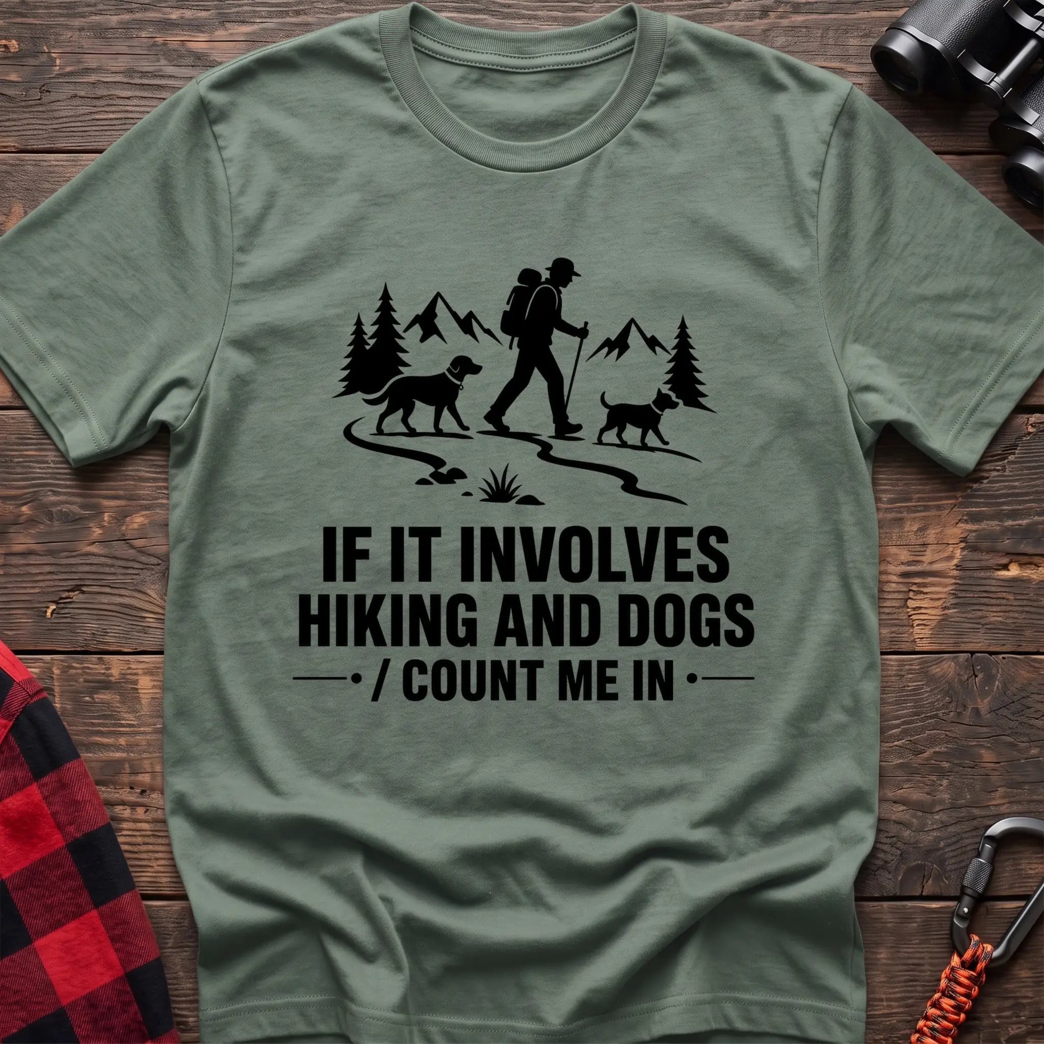 Sage cotton hiking t-shirt with hiker and two dogs silhouette on a mountain trail and "If it involves hiking and dogs count me in" quote