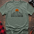 Sage t-shirt with minimalist mountain and sun graphic reading Seek Elevation