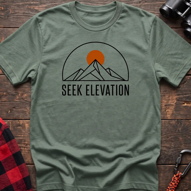 Sage t-shirt with minimalist mountain and sun graphic reading Seek Elevation