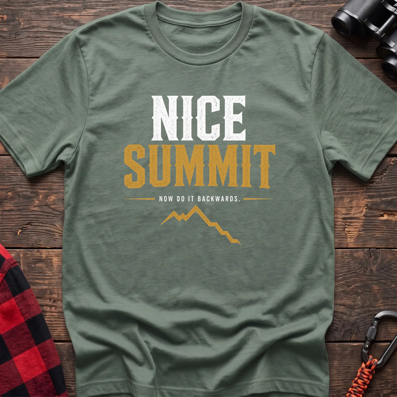 Sage cotton t-shirt with a mountain graphic and Nice Summit Now Do It Backwards text on rustic wood